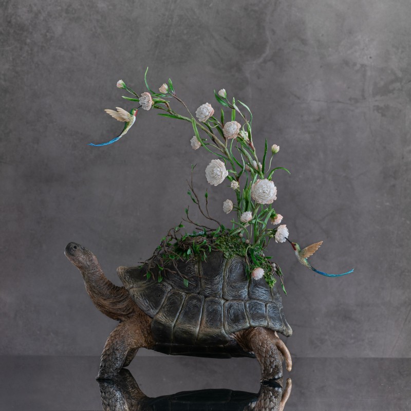 Handmade tortoise statue with flowers and hummingbird 