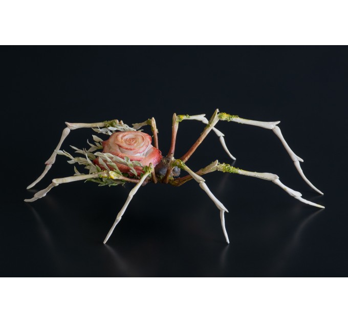 Handmade spider sculpture with a rose made of air clay.