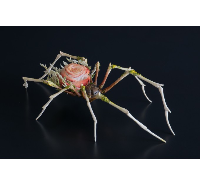 Handmade spider sculpture with a rose made of air clay.