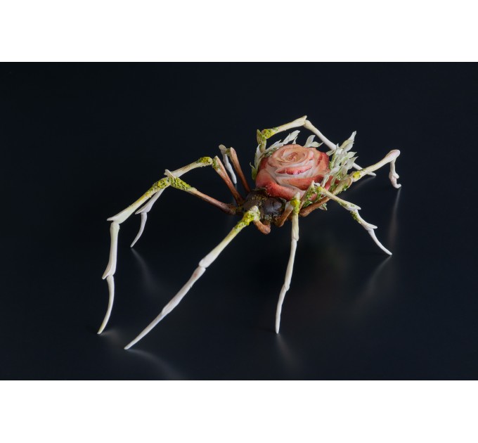 Handmade spider sculpture with a rose made of air clay.