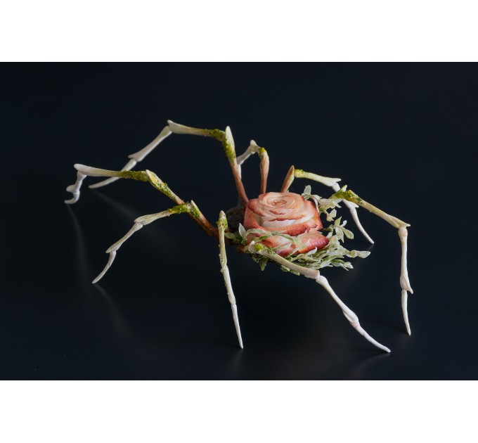 Handmade spider sculpture with a rose made of air clay.