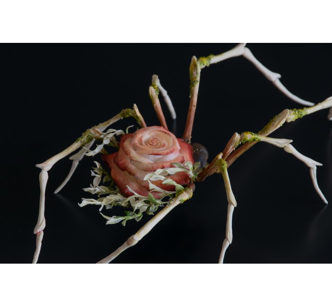 Handmade spider sculpture with a rose made of air clay.