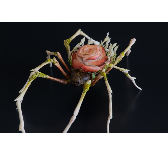 Handmade spider sculpture with a rose made of air clay.