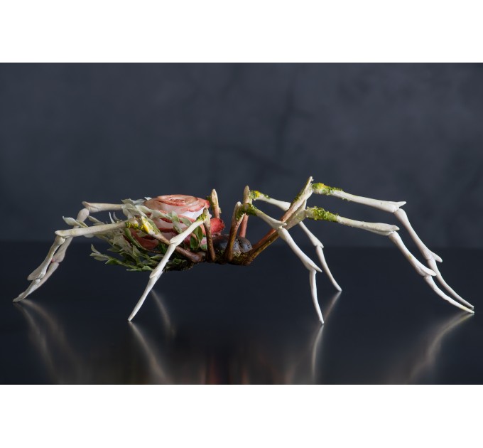 Handmade spider sculpture with a rose made of air clay.