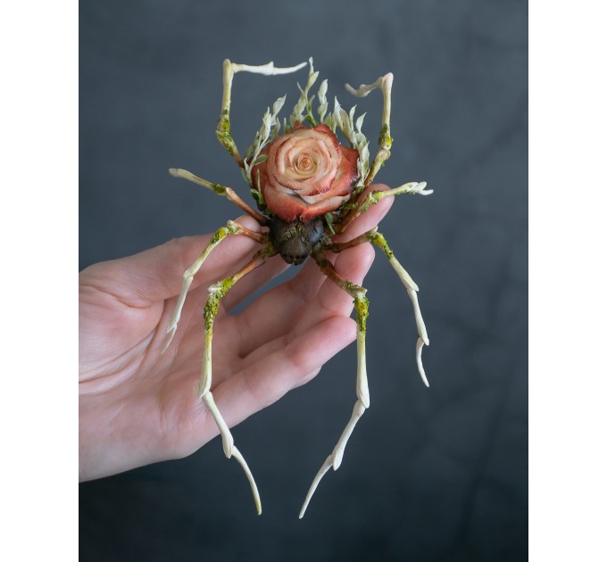 Handmade spider sculpture with a rose made of air clay.