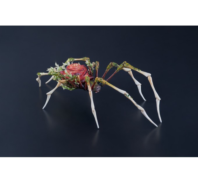 Handmade spider sculpture with a rose made of air clay