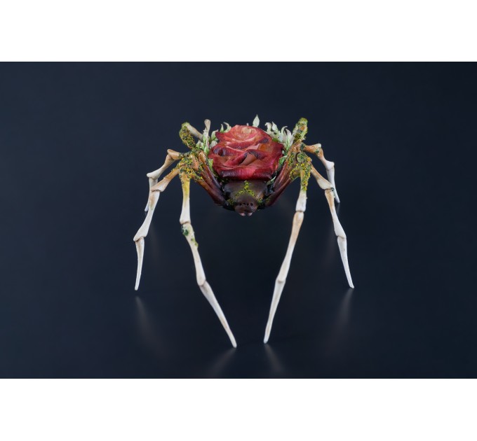 Handmade spider sculpture with a rose made of air clay