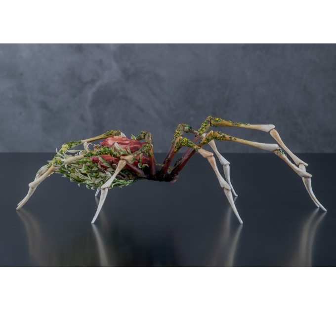 Handmade spider sculpture with a rose made of air clay.