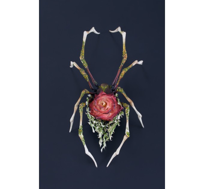Handmade spider sculpture with a rose made of air clay