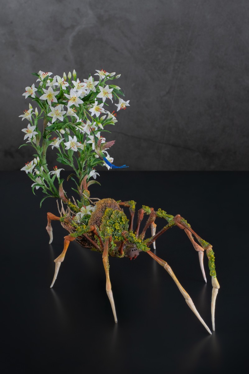 Spider sculpture with lilies made of air clay