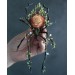 Handmade black spider sculpture with a rose made of air clay