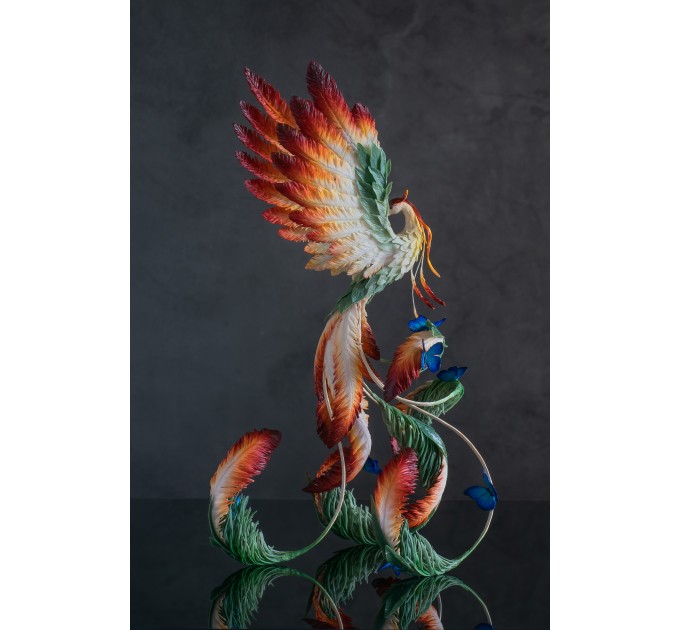 Phoenix Statue bird with blue butterfly made of air clay. Fire bird