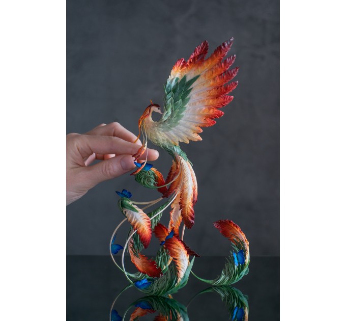 Phoenix Statue bird with blue butterfly made of air clay. Fire bird