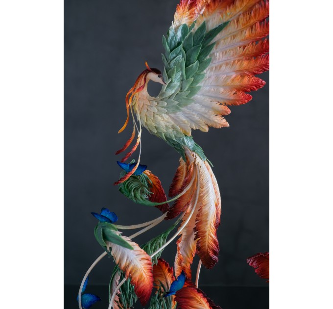 Phoenix Statue bird with blue butterfly made of air clay. Fire bird