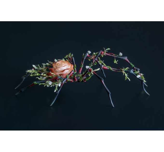 Handmade black spider sculpture with a rose made of air clay