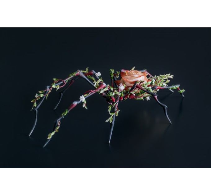 Handmade black spider sculpture with a rose made of air clay