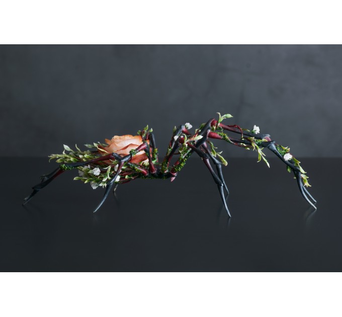 Handmade black spider sculpture with a rose made of air clay