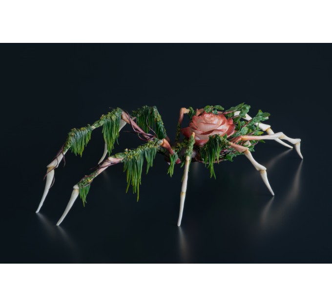 Handmade spider sculpture with a rose made of air clay.