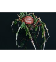 Handmade spider sculpture with a rose and moss made of air clay