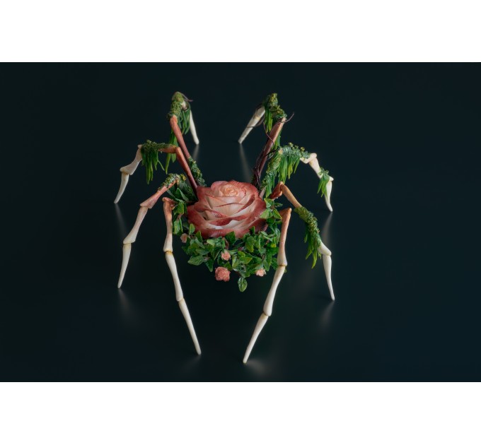 Handmade spider sculpture with a rose made of air clay.