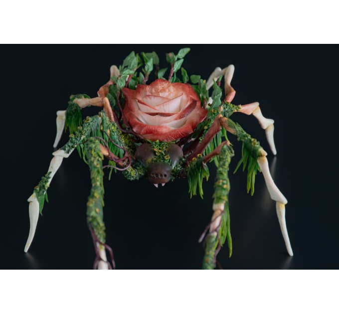 Handmade spider sculpture with a rose made of air clay.