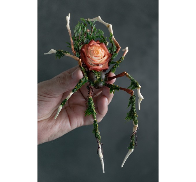 Handmade spider sculpture with a rose made of air clay.