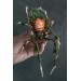 Handmade spider sculpture with a rose made of air clay.