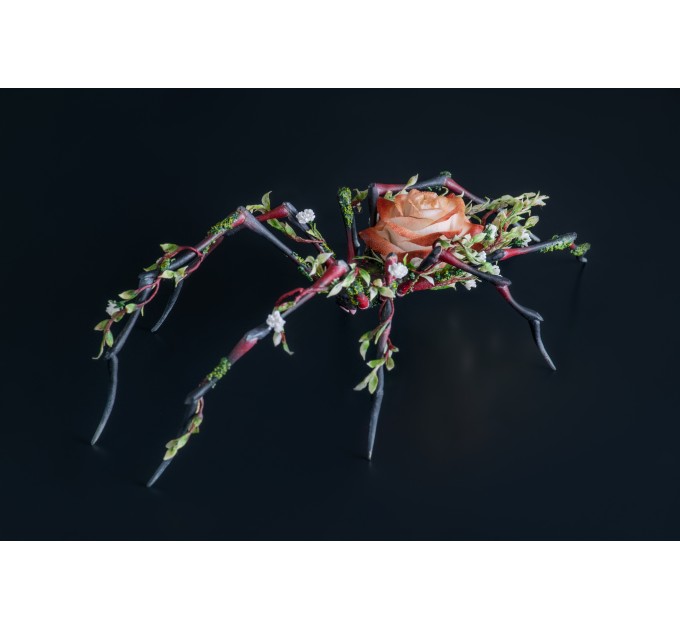 Handmade black spider sculpture with a rose made of air clay