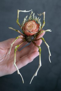 Collectible Handmade spider sculpture with a rose made of air clay.